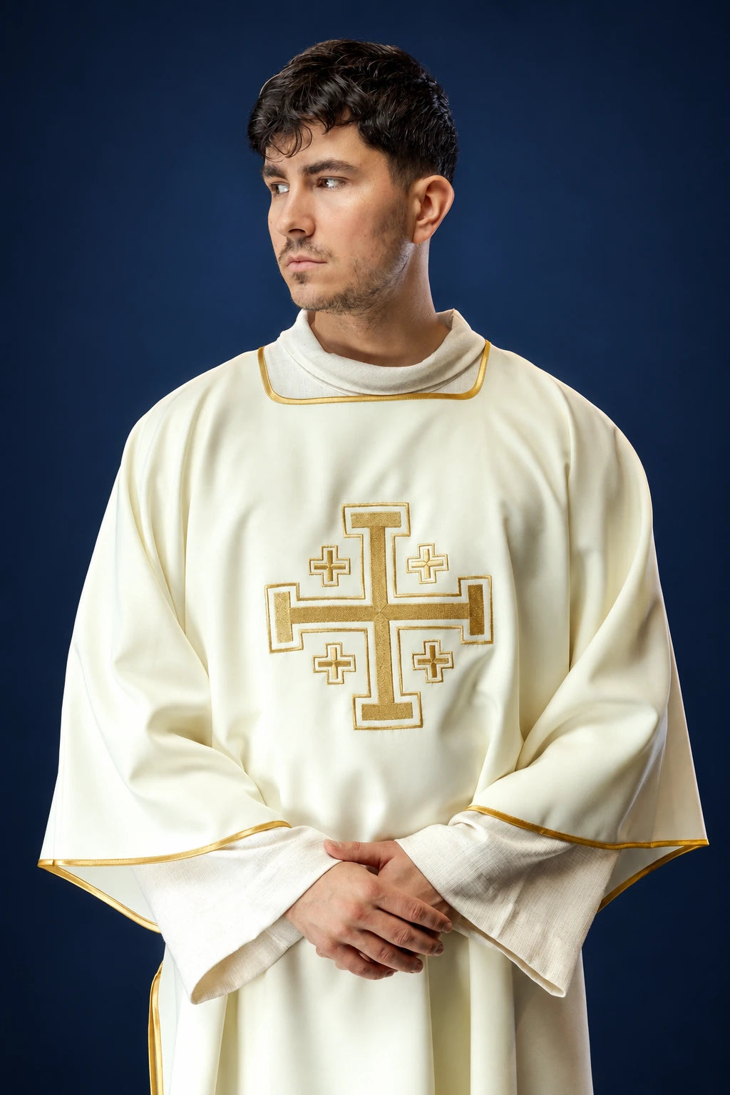 Front view of an ecru dalmatic with gold trim and large embroidered gold cross on the chest