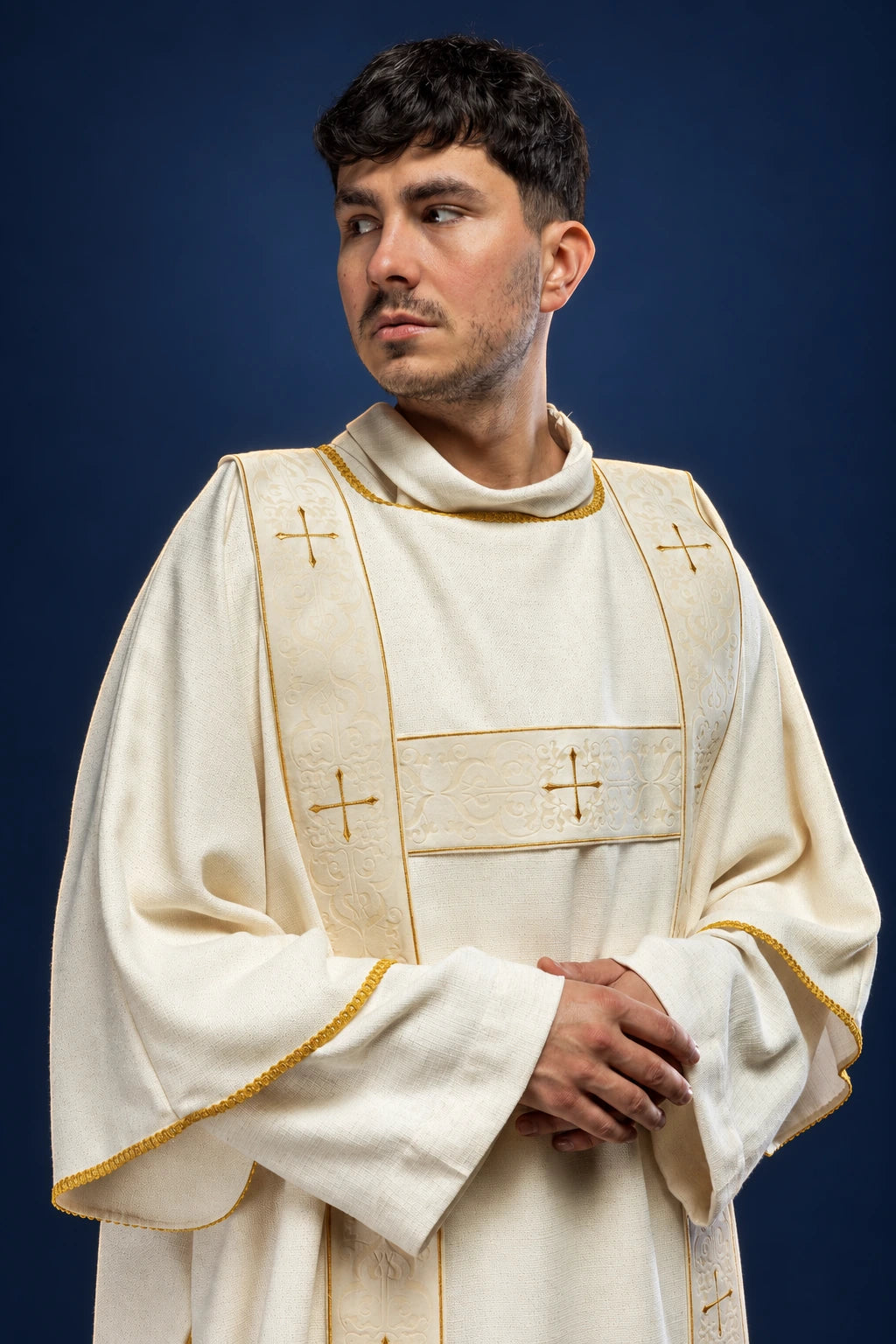 Front view of an ecru dalmatic with velvet orphreys and embroidered gold crosses