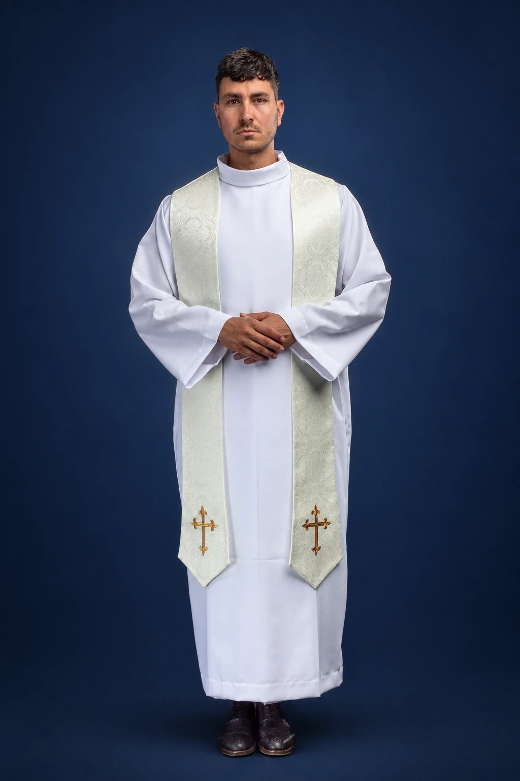 Front view of an ecru jacquard stole with embroidered cross motifs, worn over a white alb