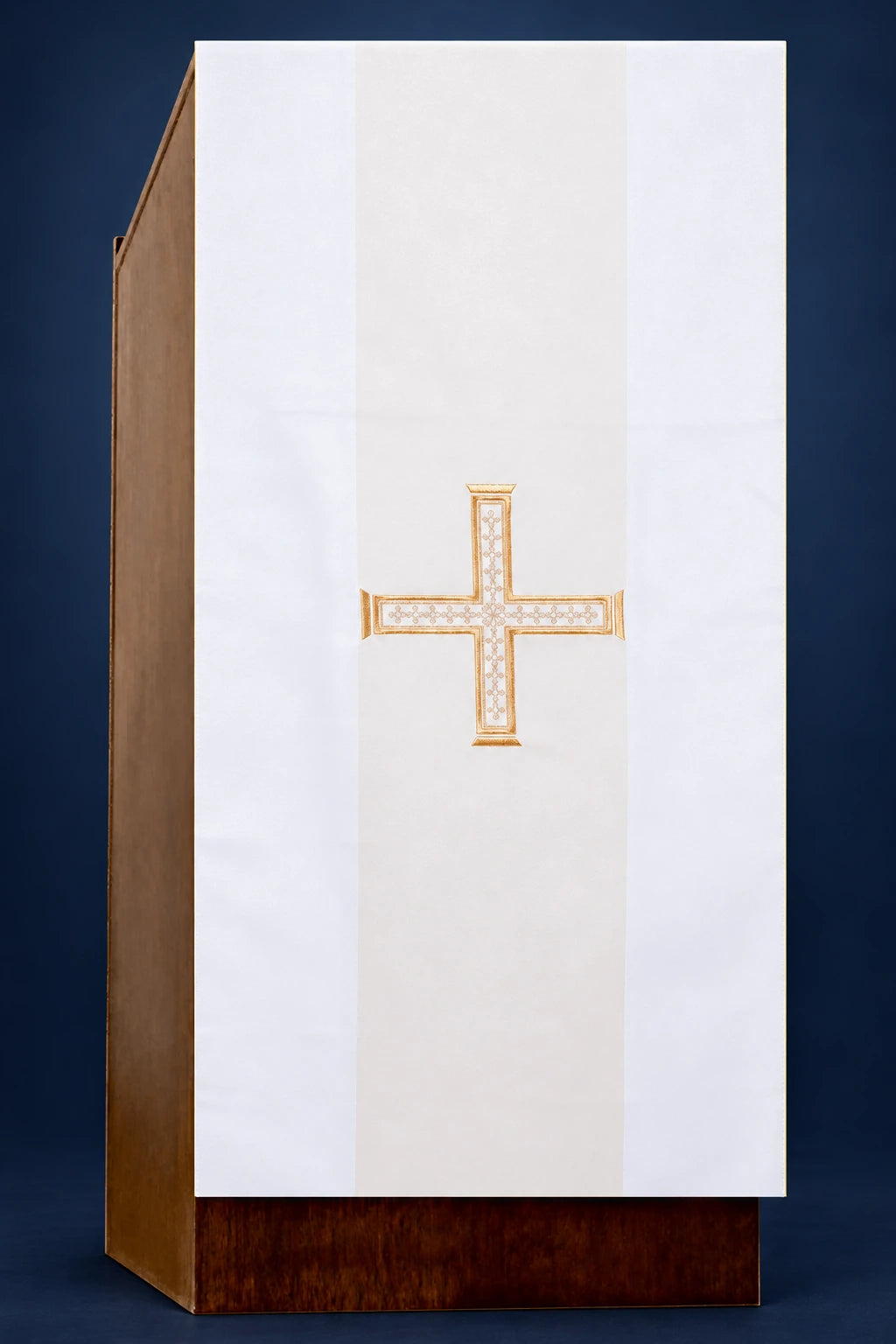 Front view of an ecru lectern cover with a gold-embroidered cross centered on the panel