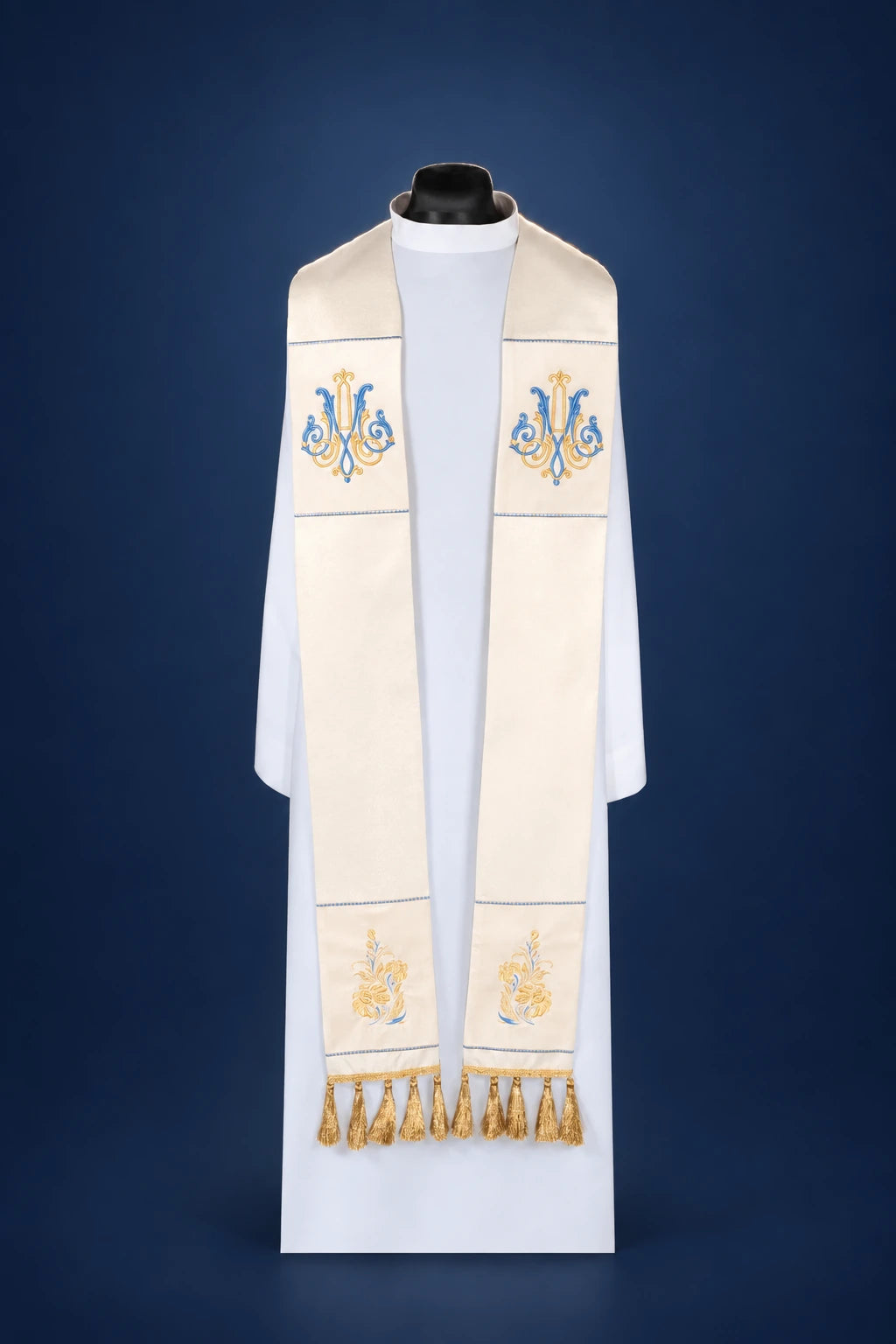 Front view of an ecru Marian stole with blue and gold embroidery and gold fringe