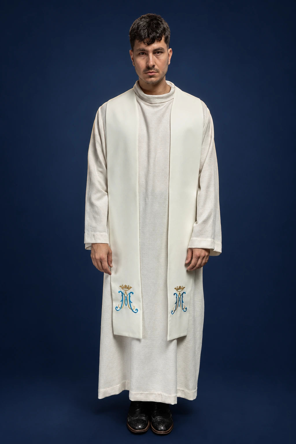 Front view of an ecru Marian stole with crowned blue and gold embroidery near the hem