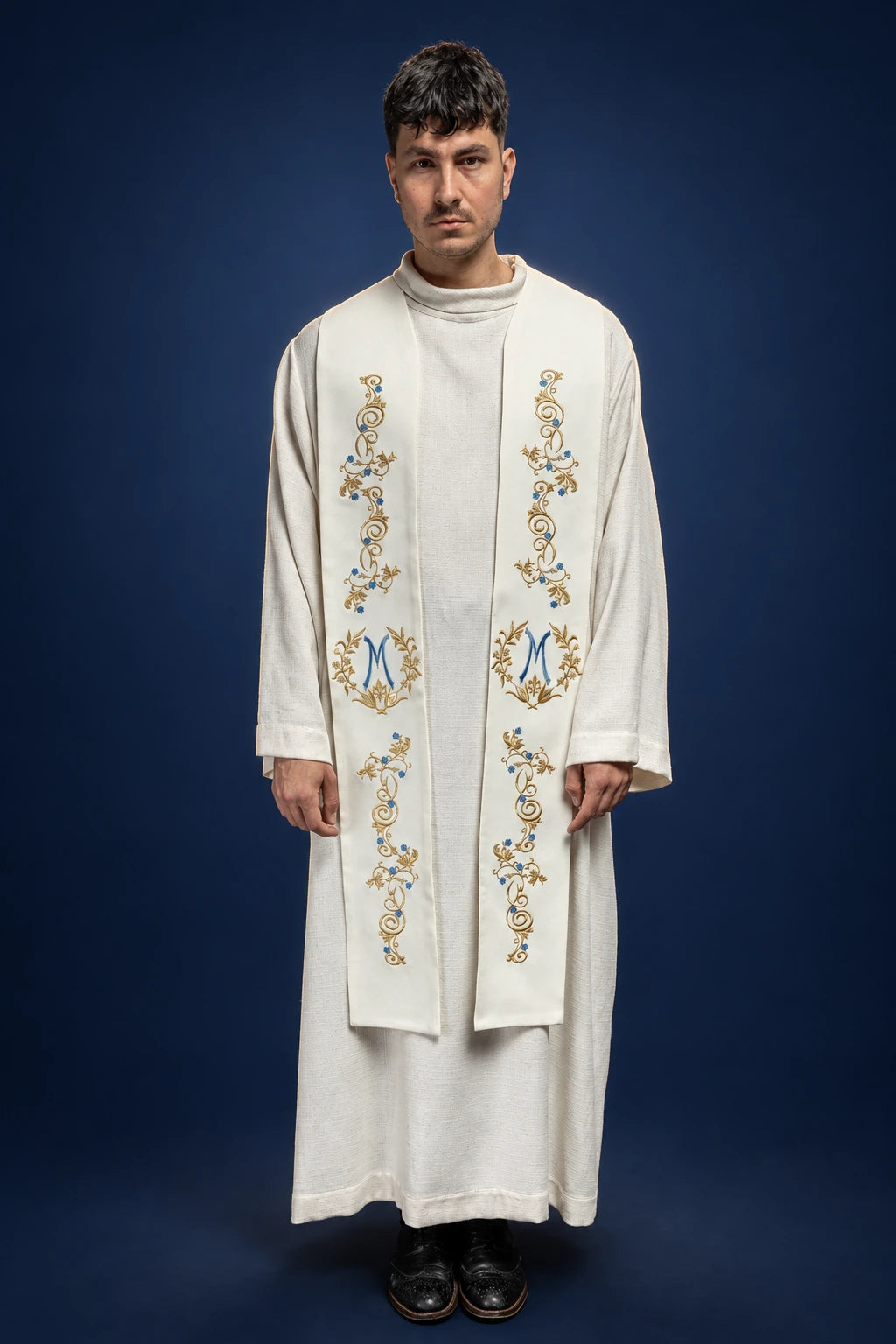 Front view of ecru Marian stole with gold laurel wreath and blue monogram embroidery