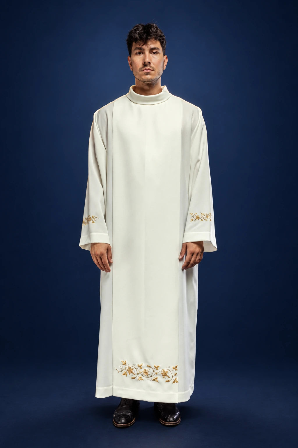 Front view of an ecru priest alb with stand-up collar and floral embroidery at the hem and cuffs
