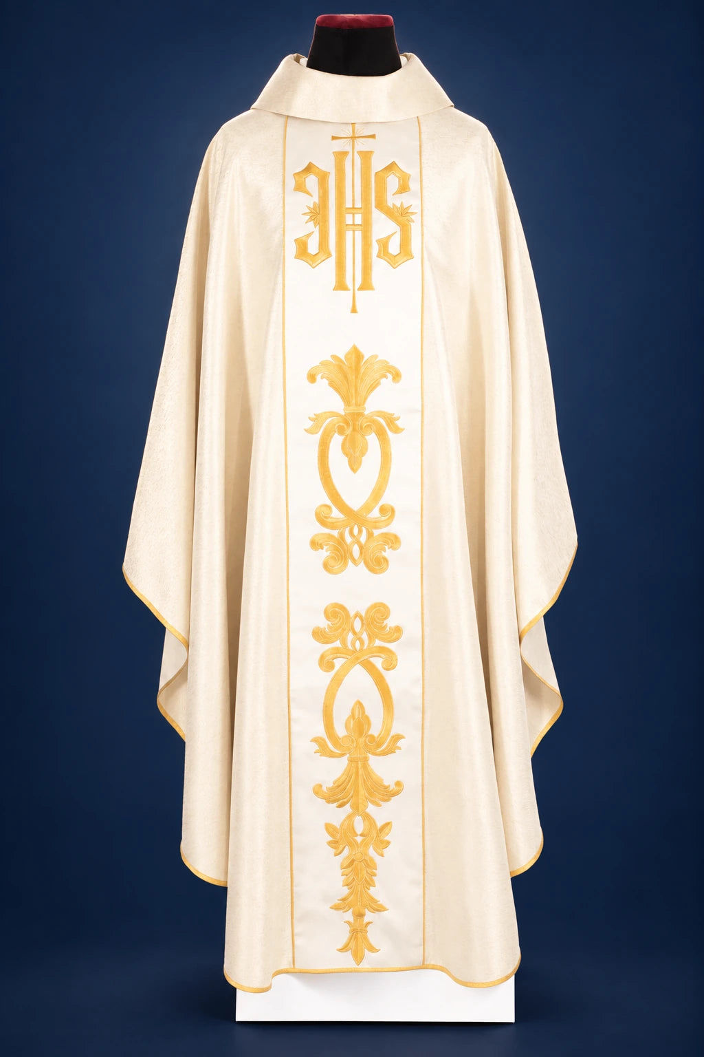 Front view of a gold chasuble with wide central IHS orphrey and ornate gold vine motif