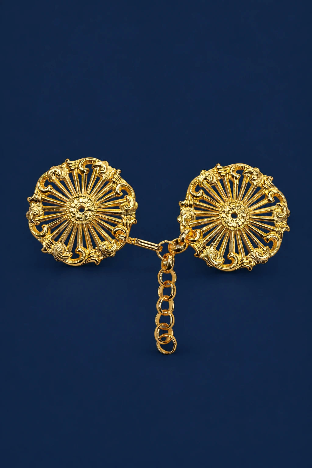 Front view of a gold cope clasp with two ornate round medallions linked by a short chain