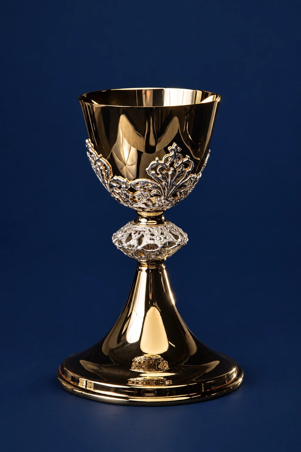 Front view of a gold-plated brass chalice with ornate silver embellishments on the stem and base