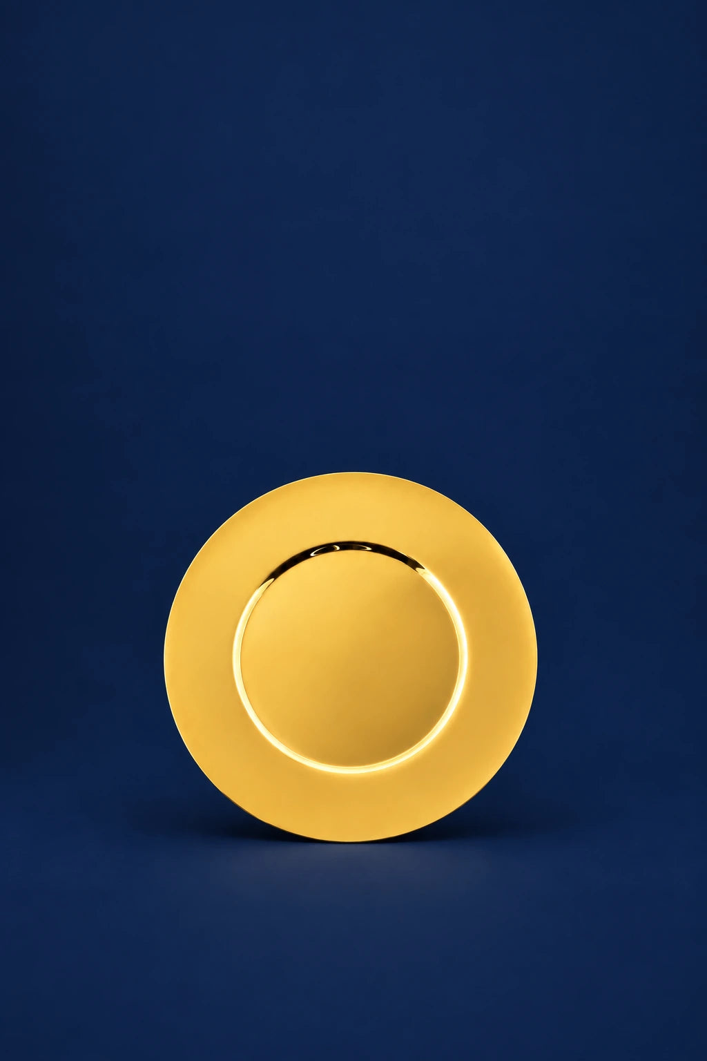 Front view of a gold-plated brass communion paten with a smooth raised rim