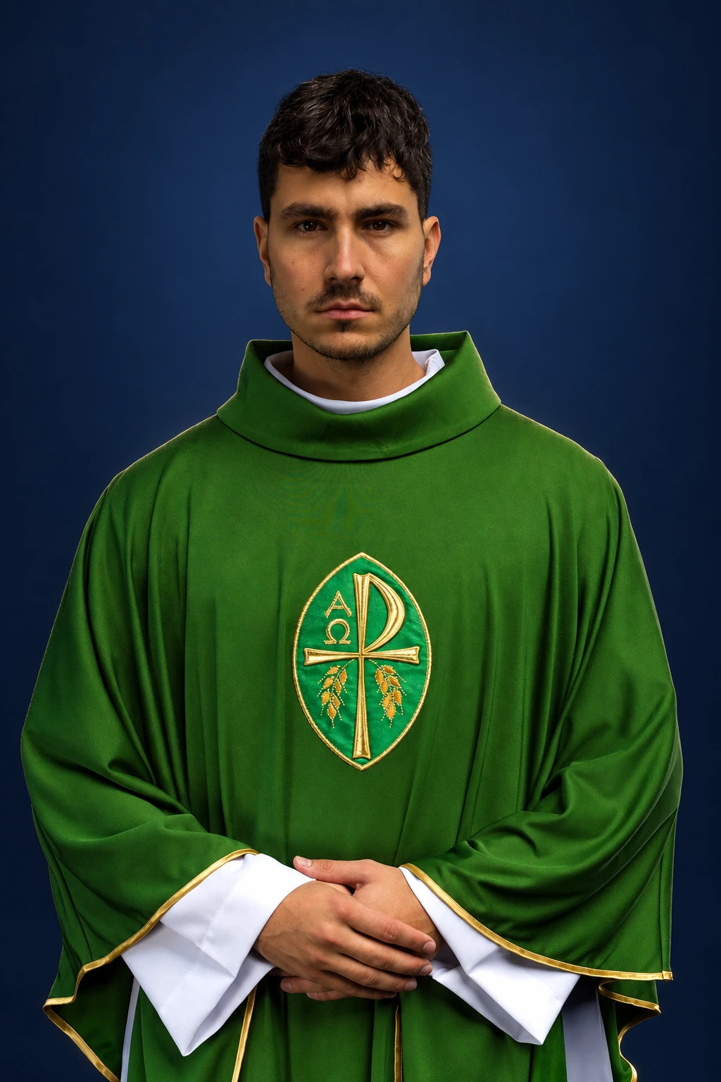 Front view of a green chasuble with embroidered cross and gold trim, worn over a white alb