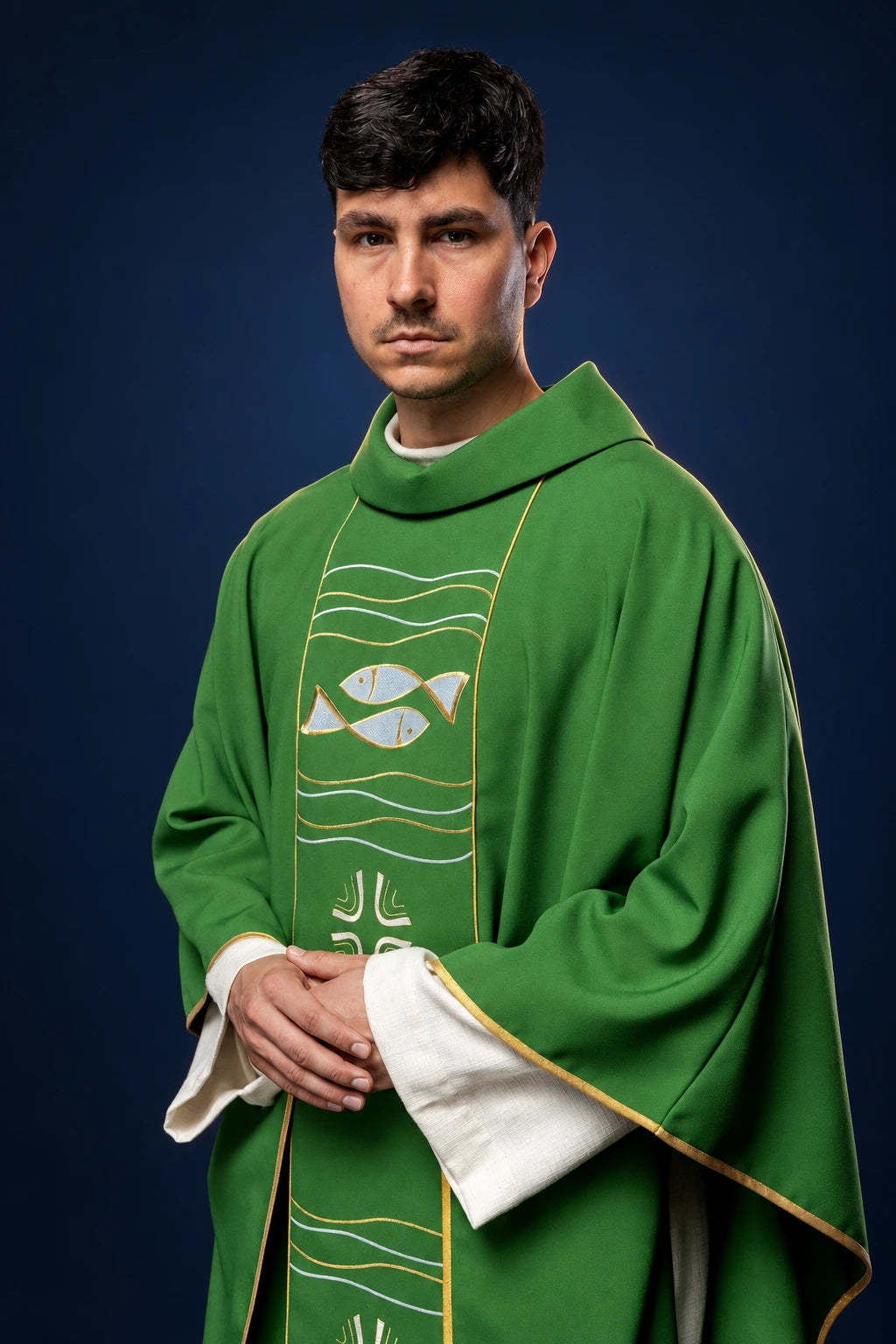 Front view of a green chasuble with embroidered fish, wave lines, and cross detail on the orphrey