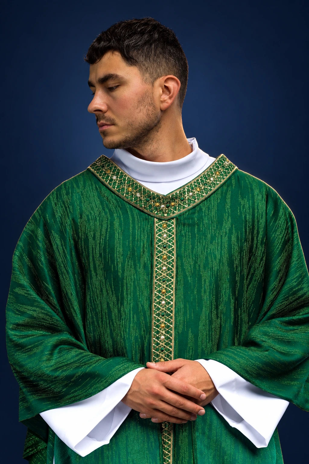 Front view of green chasuble with embroidered orphrey and collar over white sleeves