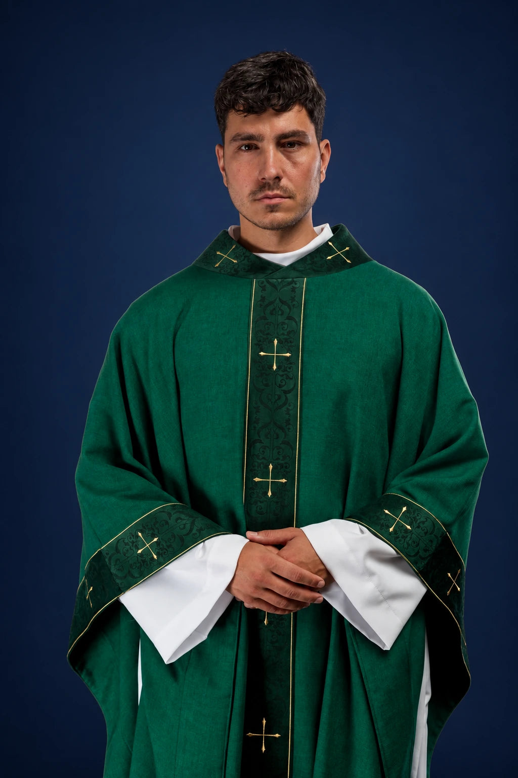 Front view of a green chasuble with embroidered vertical orphrey and cross-patterned collar and cuffs