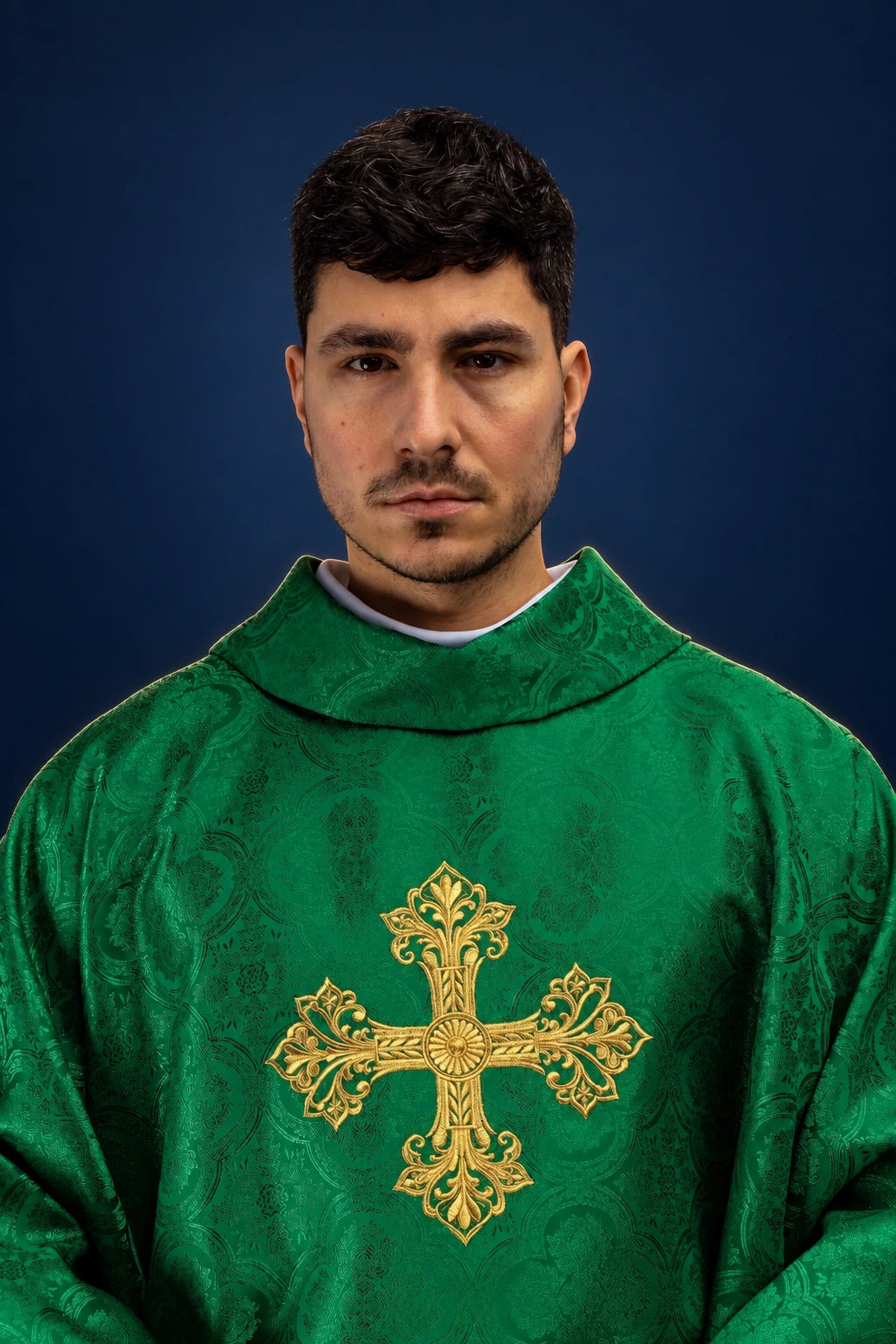 Front view of a green chasuble with a gold cross motif and jacquard pattern.