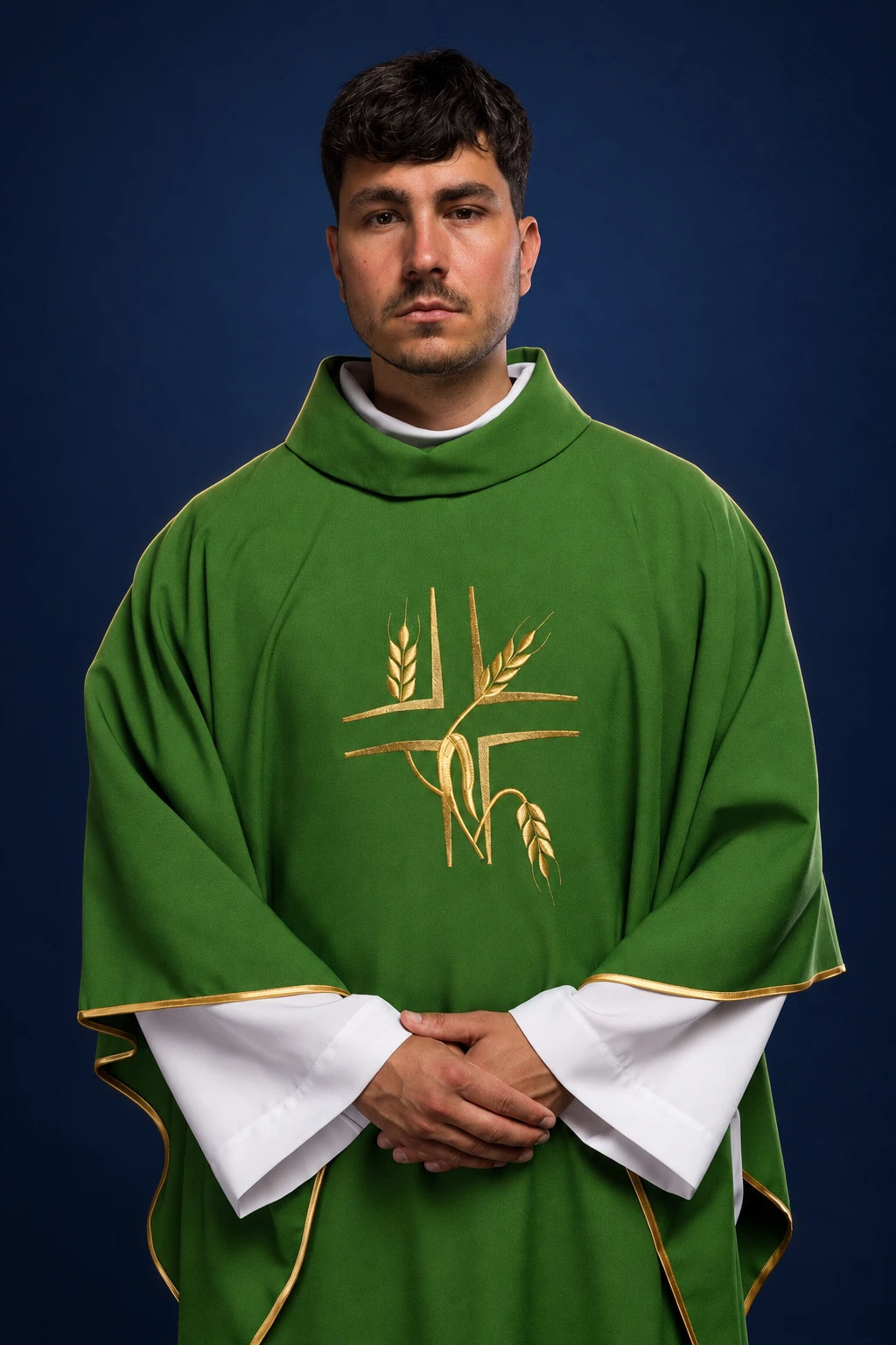 Front view of a green chasuble with gold cross and wheat embroidery, gold trim, and white under-sleeves