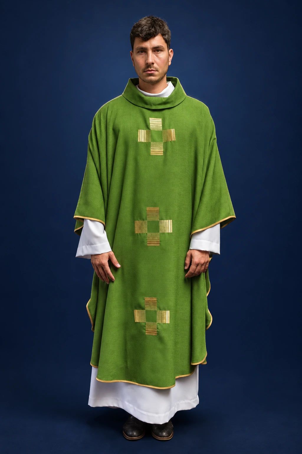 Front view of a green chasuble with gold-embroidered crosses, worn over a white alb