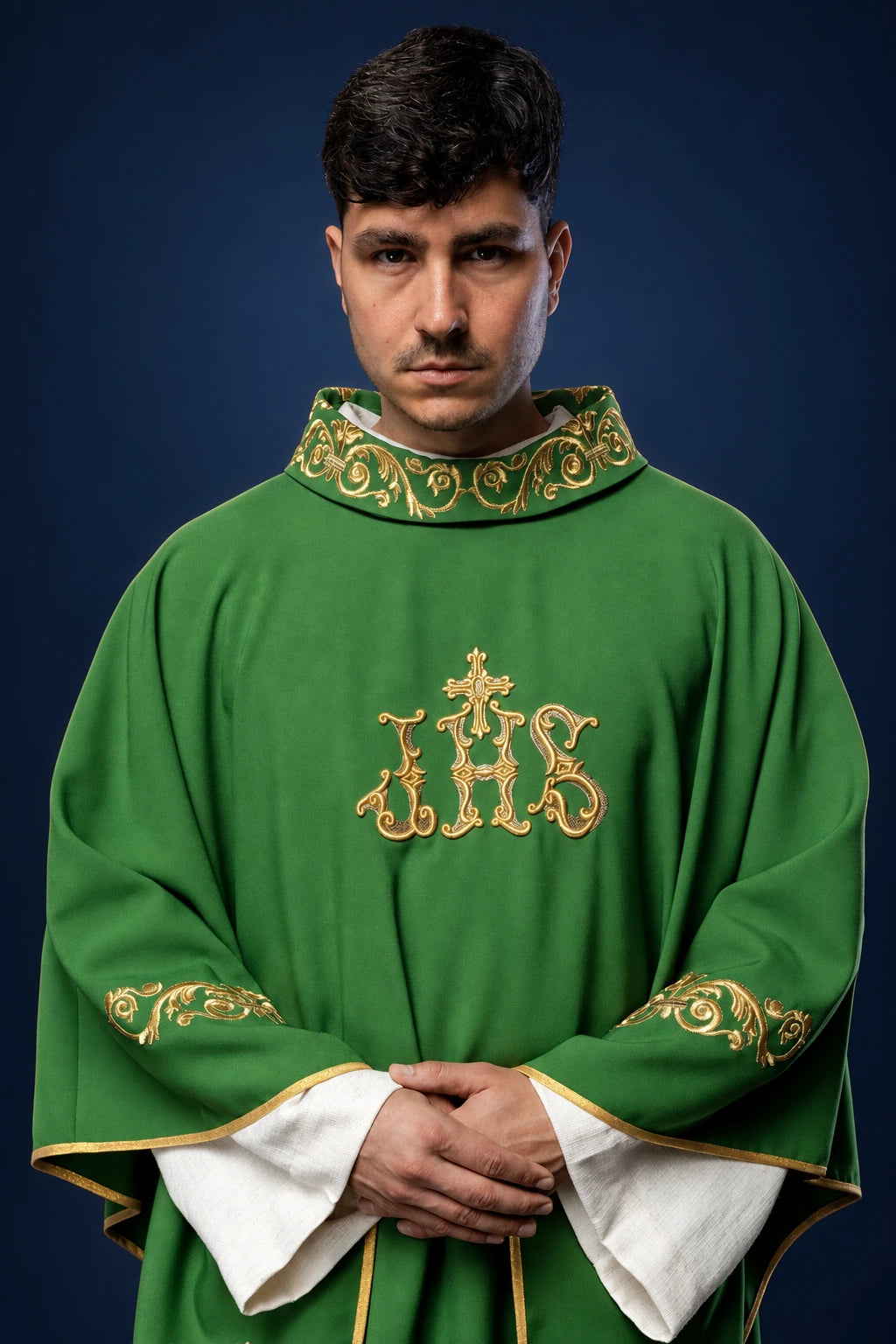 Front view of green chasuble with gold IHS embroidery and gold satin trim at collar and sleeves