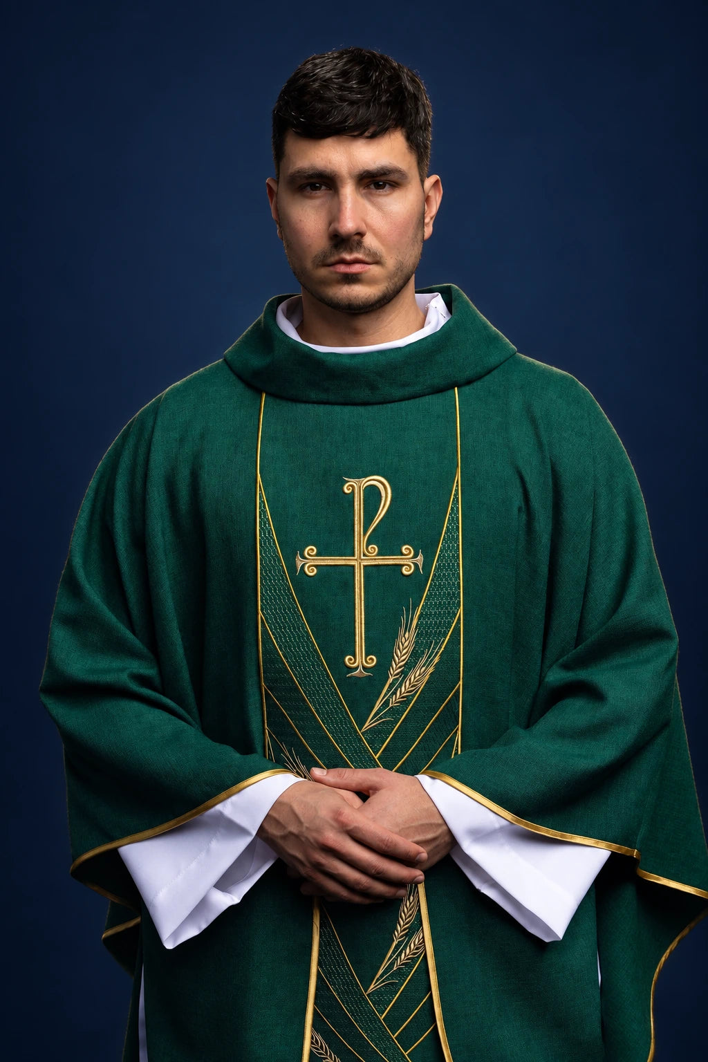 Front view of a green chasuble with gold PAX cross orphrey and wheat embroidery, worn over a white alb