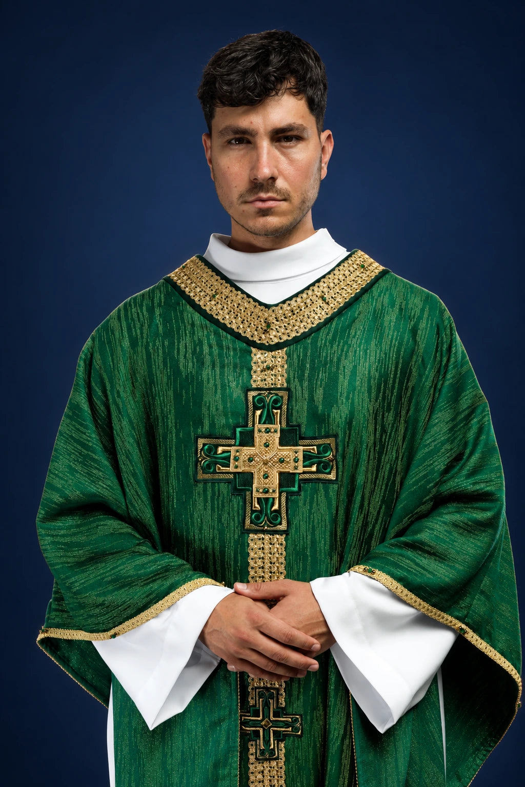 Front view of a green chasuble with gold trim and a central embroidered cross motif.