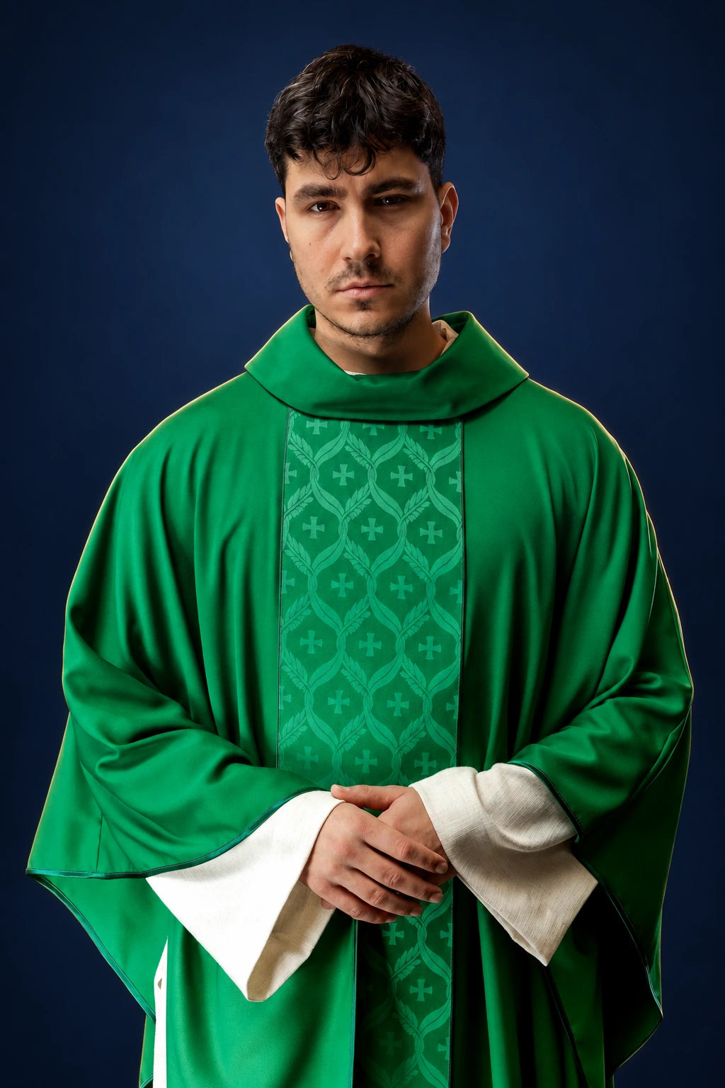 Front view of a green chasuble with a jacquard cross-patterned orphrey and white cuffs