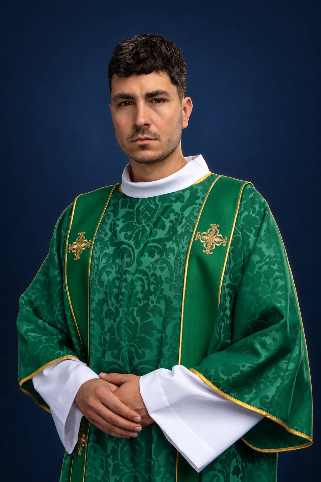 Front view of a green dalmatic with gold orphreys and embroidered gold crosses at the chest