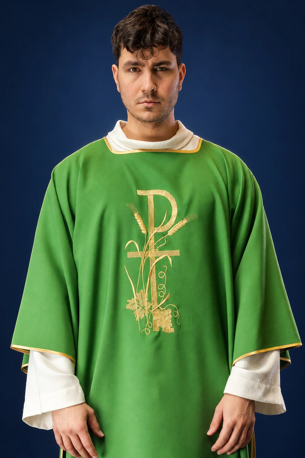 Front view of a green dalmatic with gold PAX cross embroidery and gold trim at the neckline and sleeves