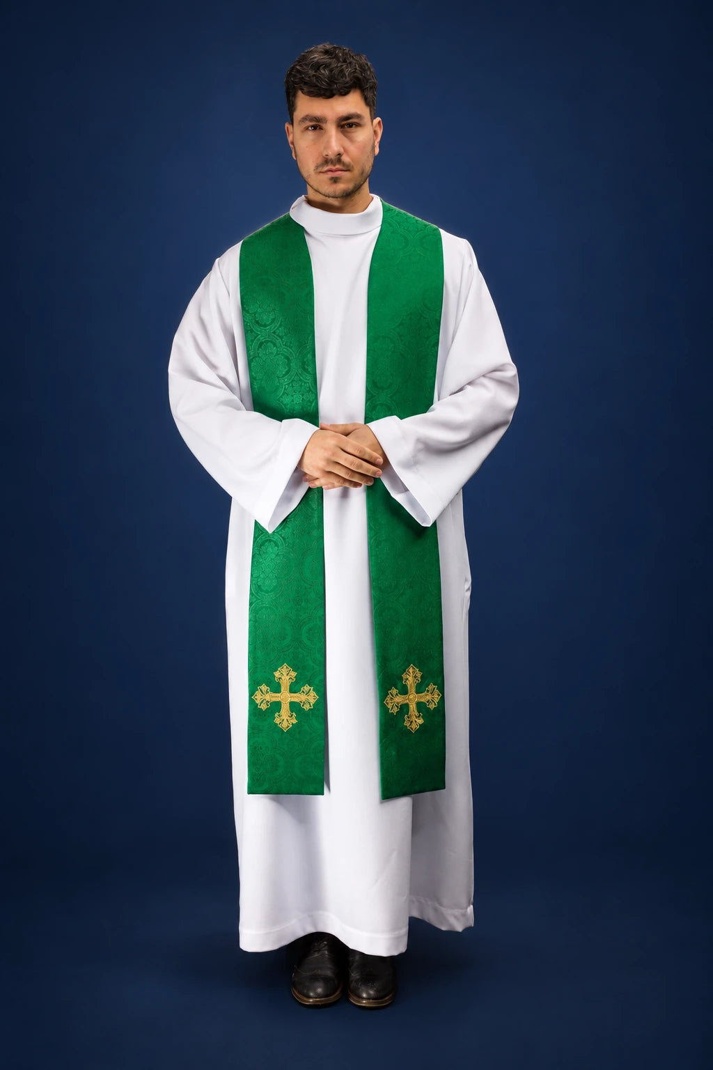 Front view of a green embroidered Catholic stole with gold crosses over a white alb