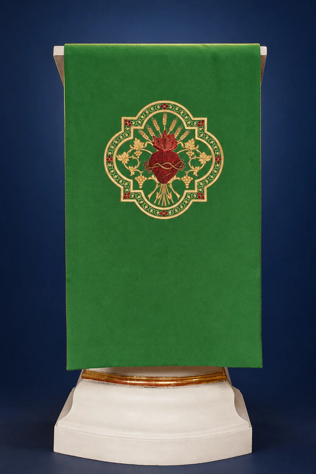 Front view of a green lectern cover with ornate embroidered red and gold heart and floral medallion