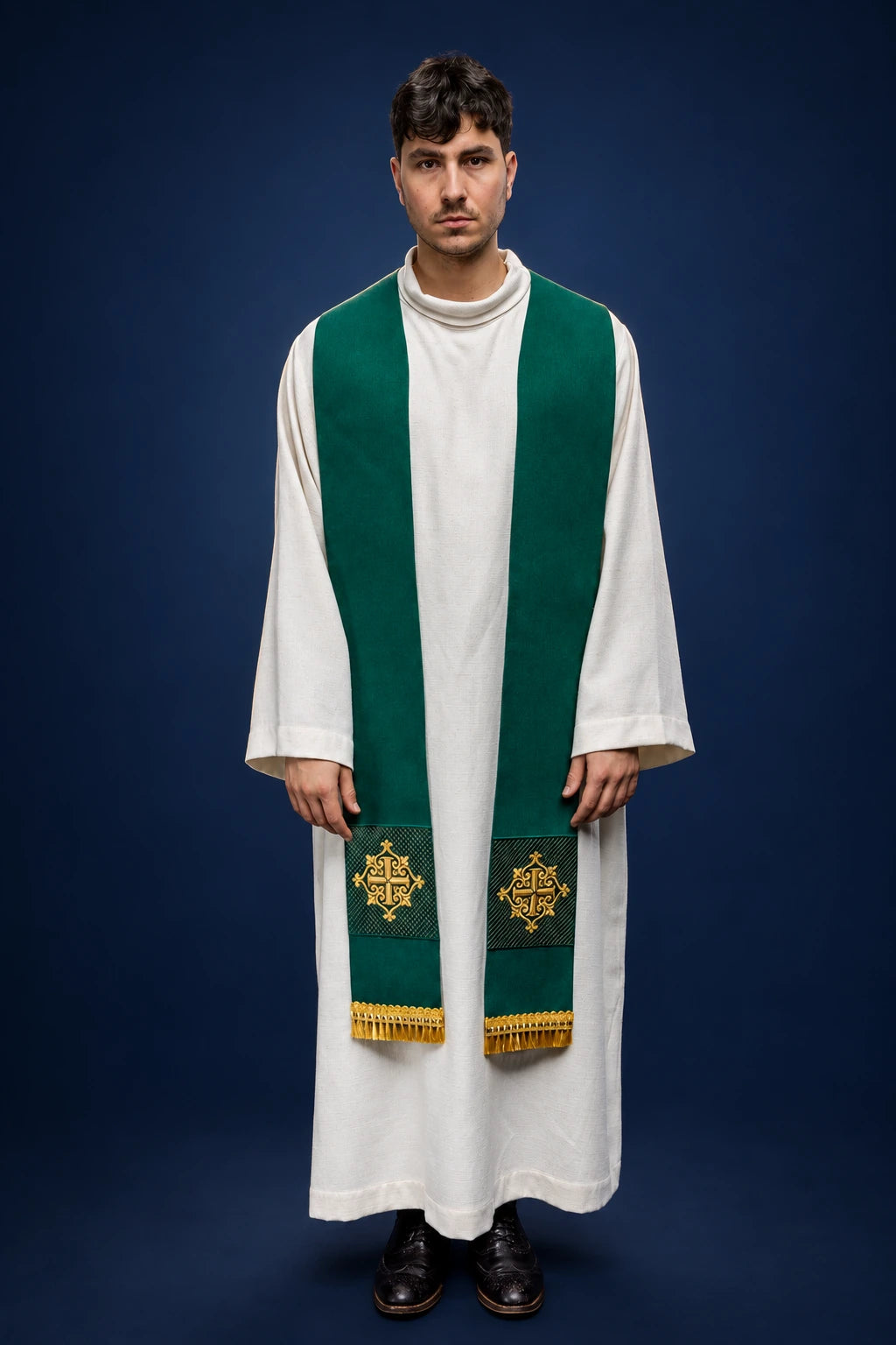 Front view of a green velvet stole with gold embroidered cross motifs and fringe at the ends