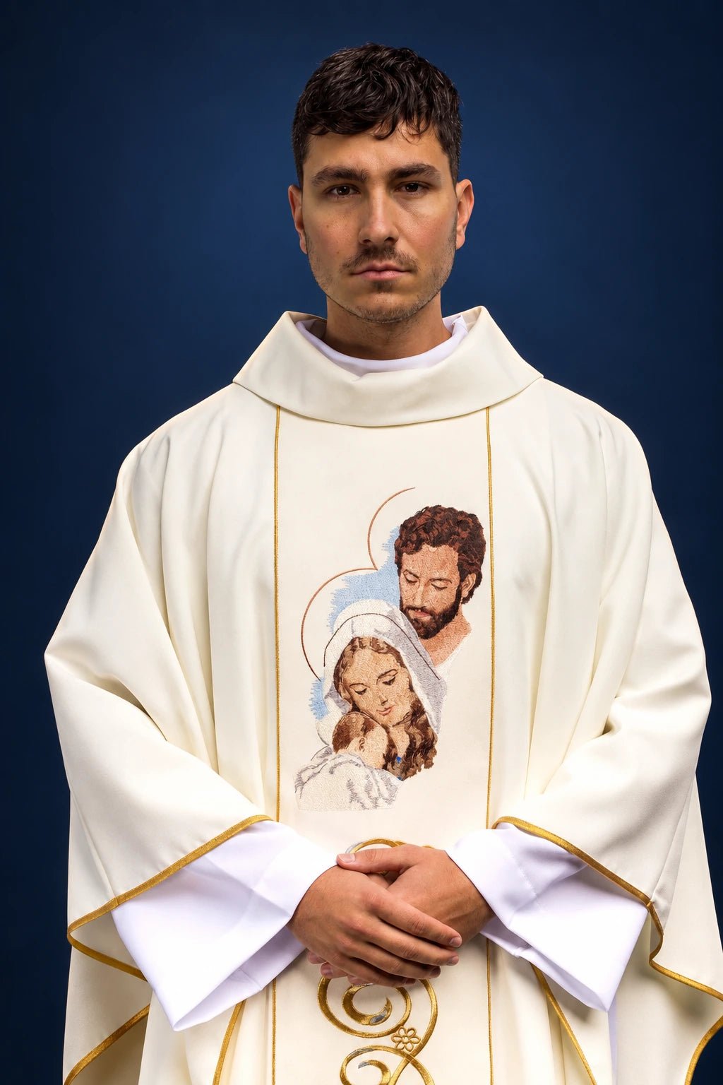 Front view of an ivory chasuble with gold piping and a Holy Family motif on the chest.