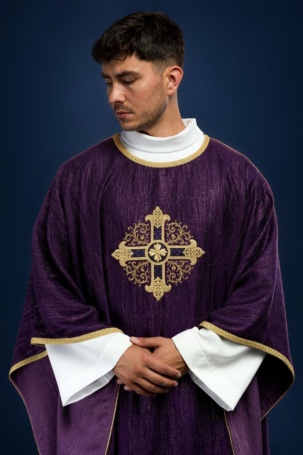 Front view of a purple Catholic chasuble with gold embroidered cross motif and gold-trimmed edges