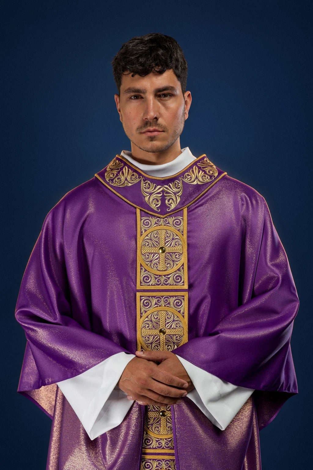 Front view of a purple chasuble with embroidered gold orphrey and cross medallions, trimmed with faceted stones.