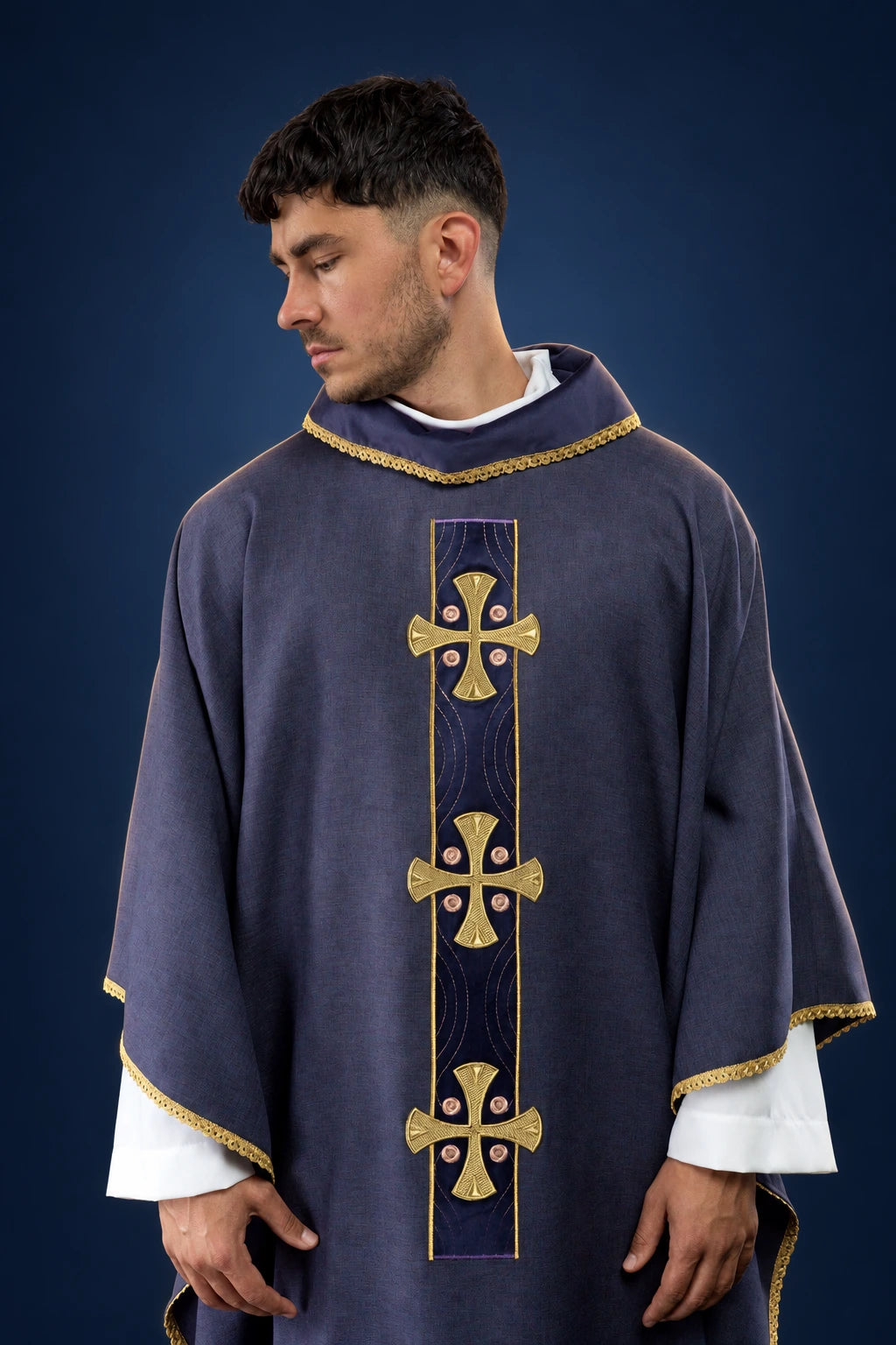 Front view of a purple chasuble with gold embroidered crosses and gold-trimmed collar and edges