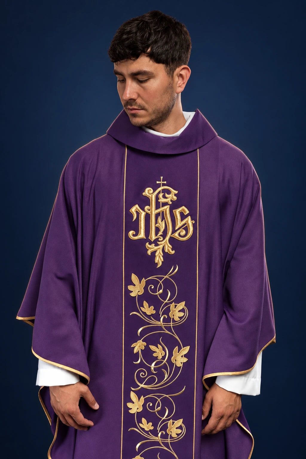 Front view of a purple chasuble with gold floral orphrey and IHS monogram on the chest