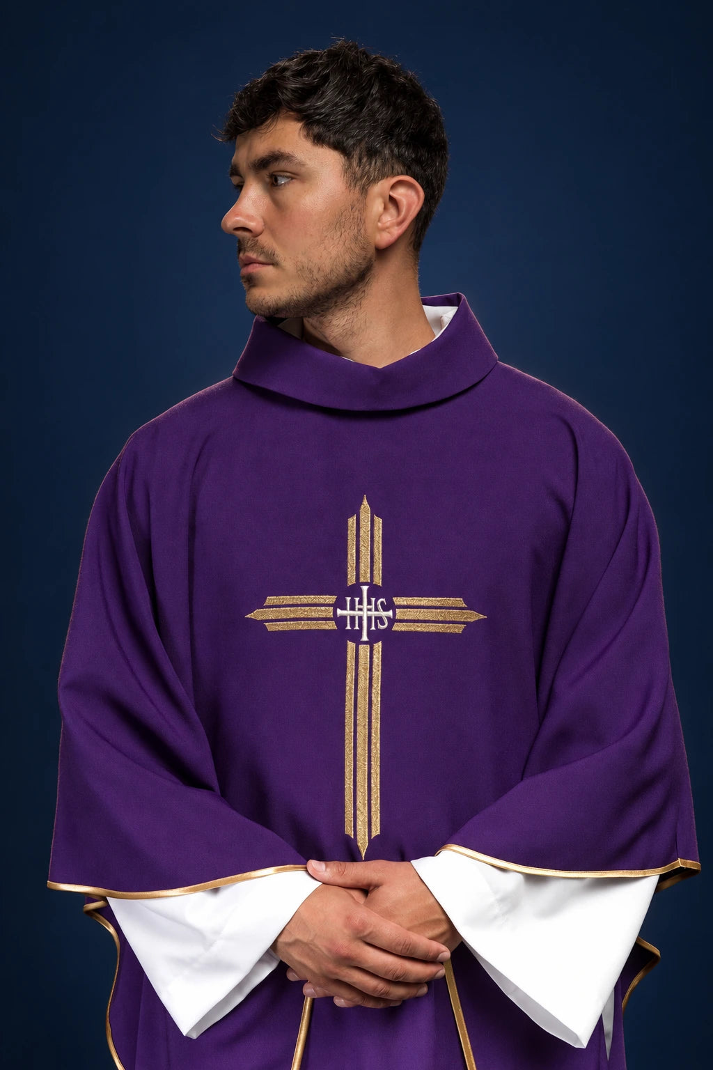 Front view of a purple chasuble with gold IHS cross embroidery and gold-trimmed edges