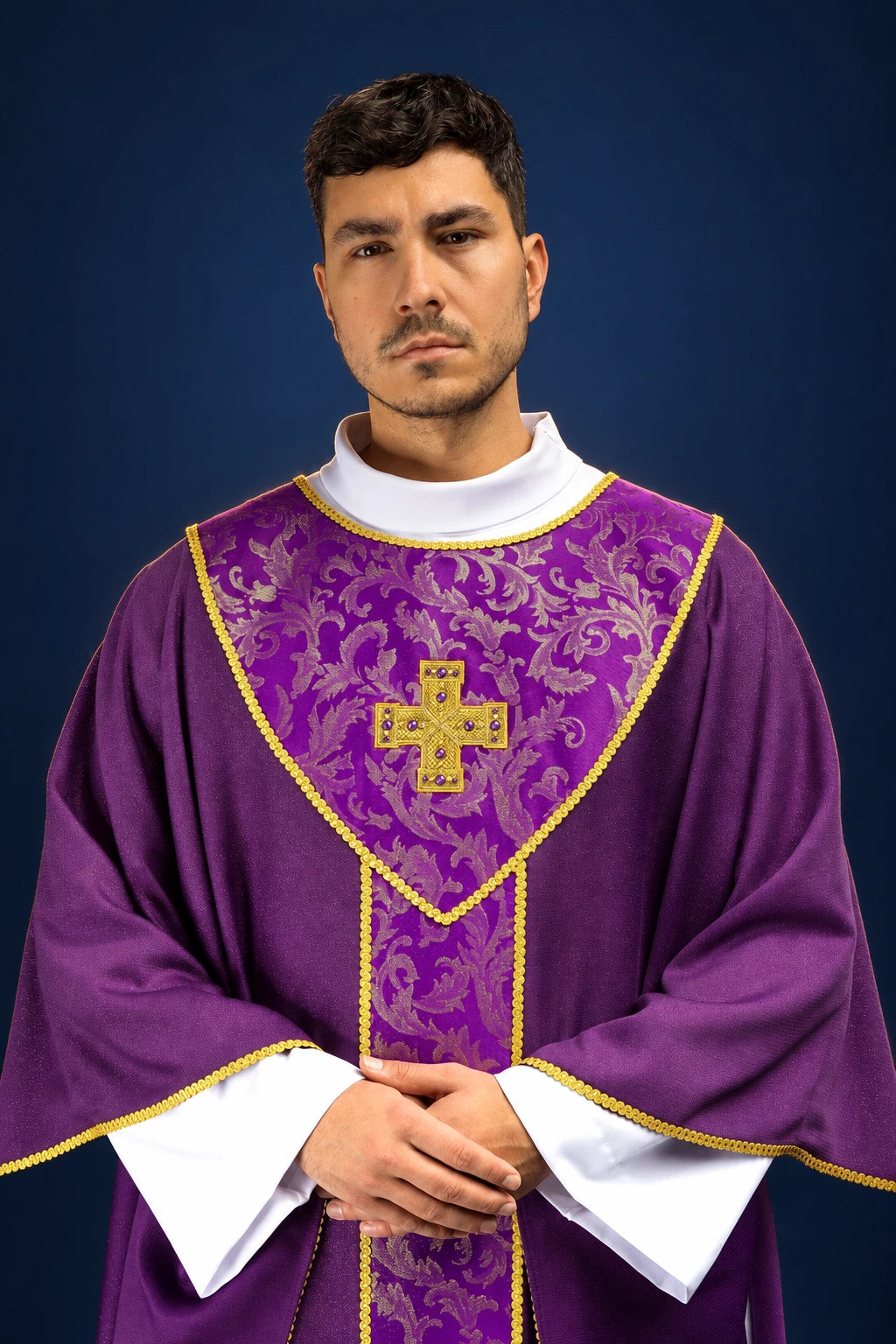 Front view of a purple chasuble with gold trim, jacquard panel, and gold cross on the chest