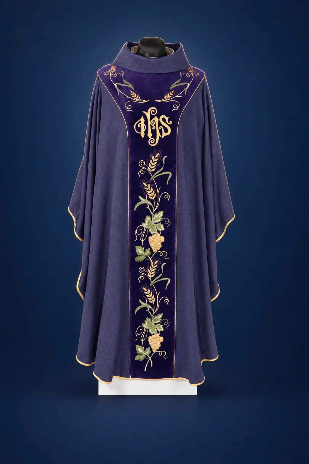 Front view of a purple chasuble with velvet orphrey, IHS embroidery, and vine floral trim