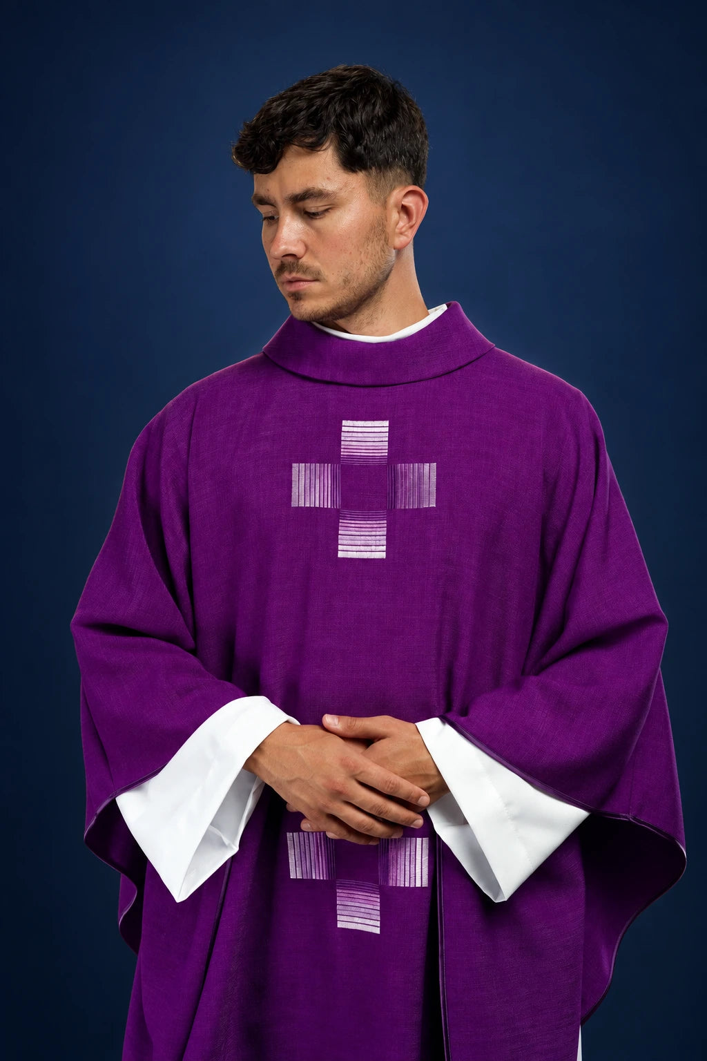 Front view of a purple chasuble with white inner stole and woven cross motif