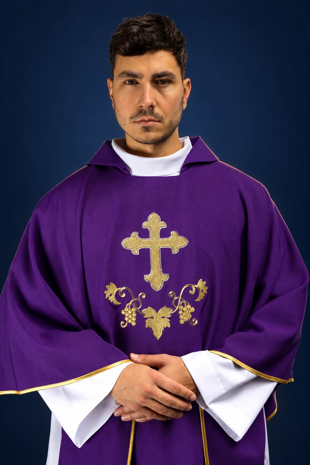 Front view of a purple chasuble with wide collar, gold cross embroidery, and ornate floral motif