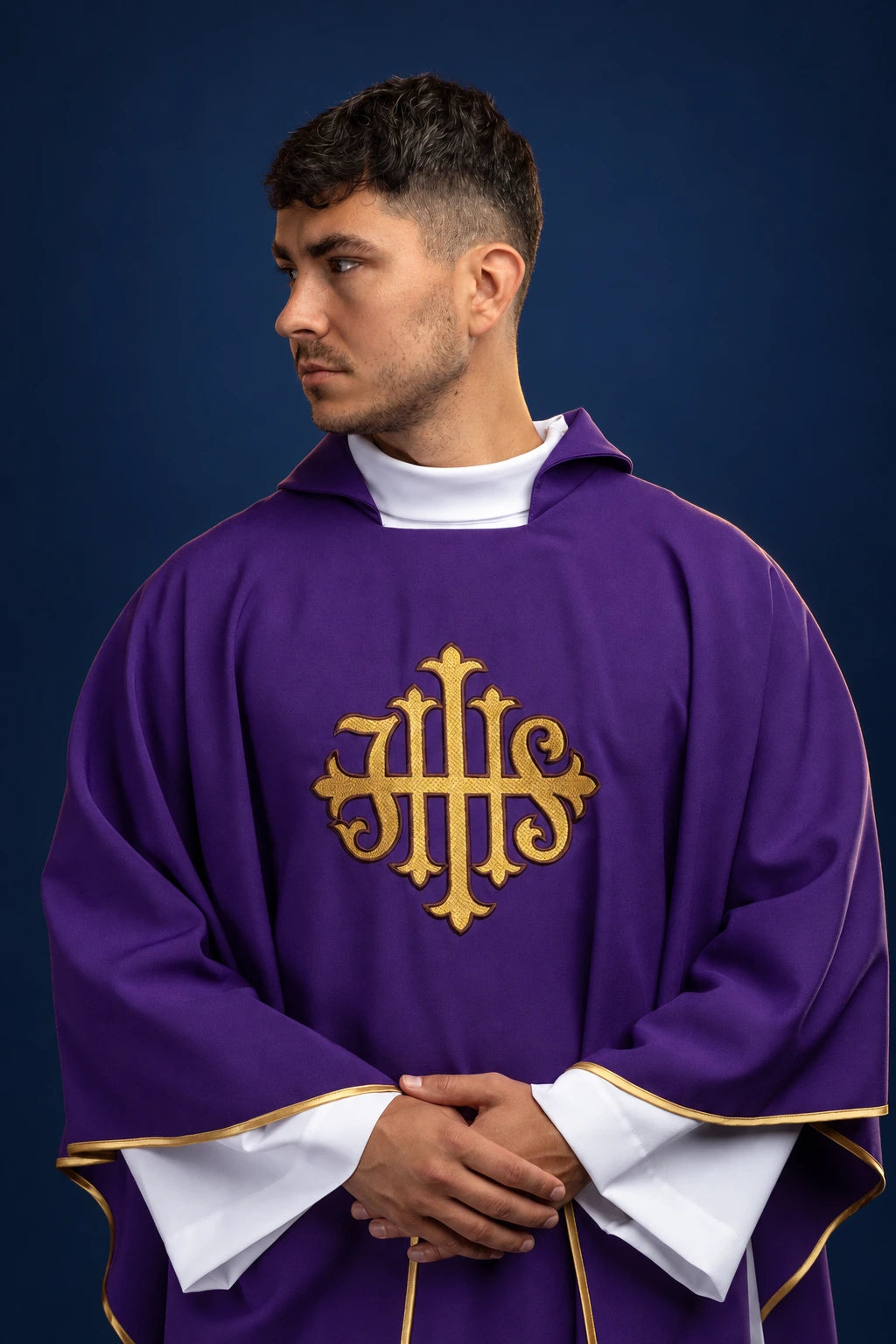 Front view of a purple chasuble with wide collar and gold JHS embroidery on the chest