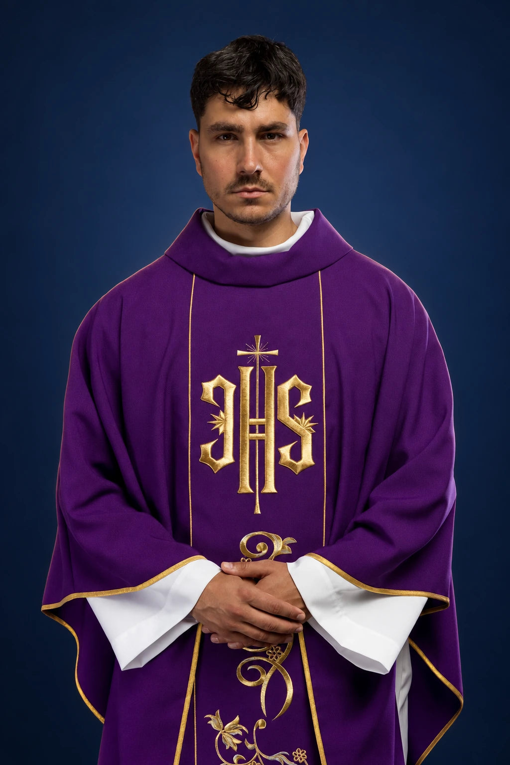 Front view of a purple chasuble with wide gold IHS orphrey and embroidered vine motif