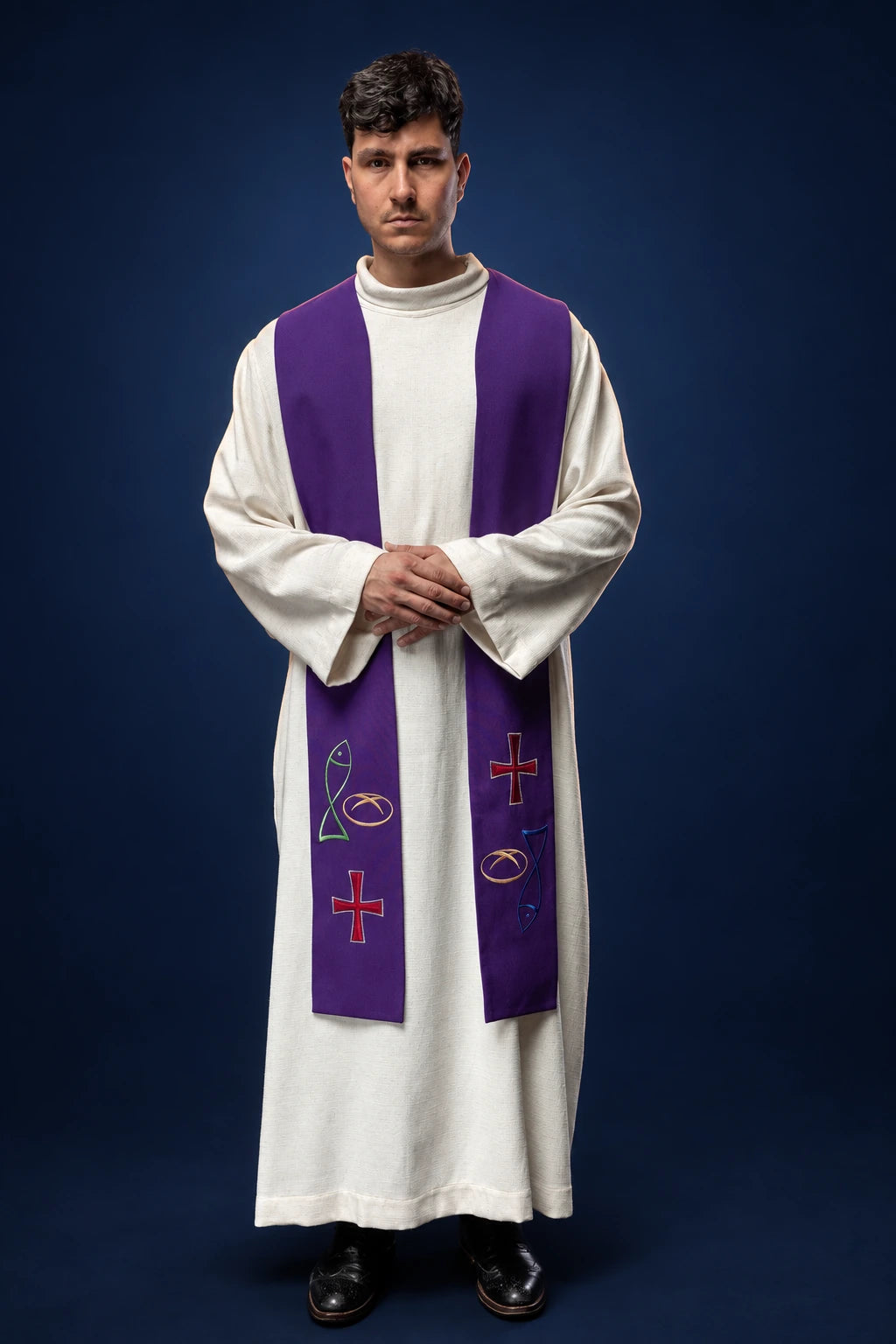 Front view of a purple priest stole with fish, bread, and cross embroidery over a white alb