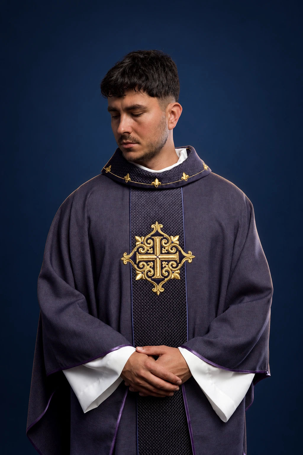 Front view of a purple velvet chasuble with gold embroidered cross and narrow central orphrey