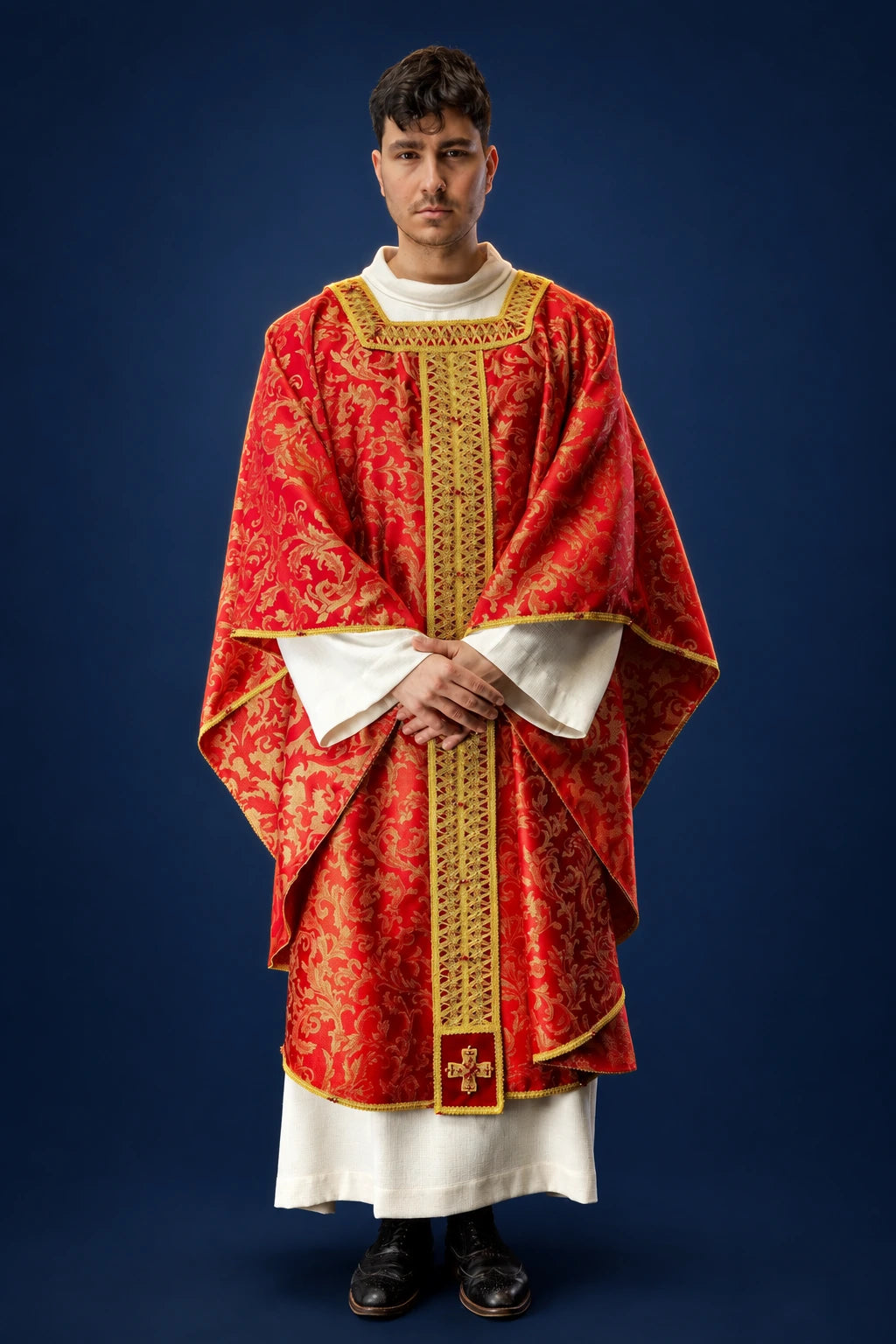 Front view of a red brocade chasuble with gold trim, wide sleeves, and a gold vertical band and cross motif