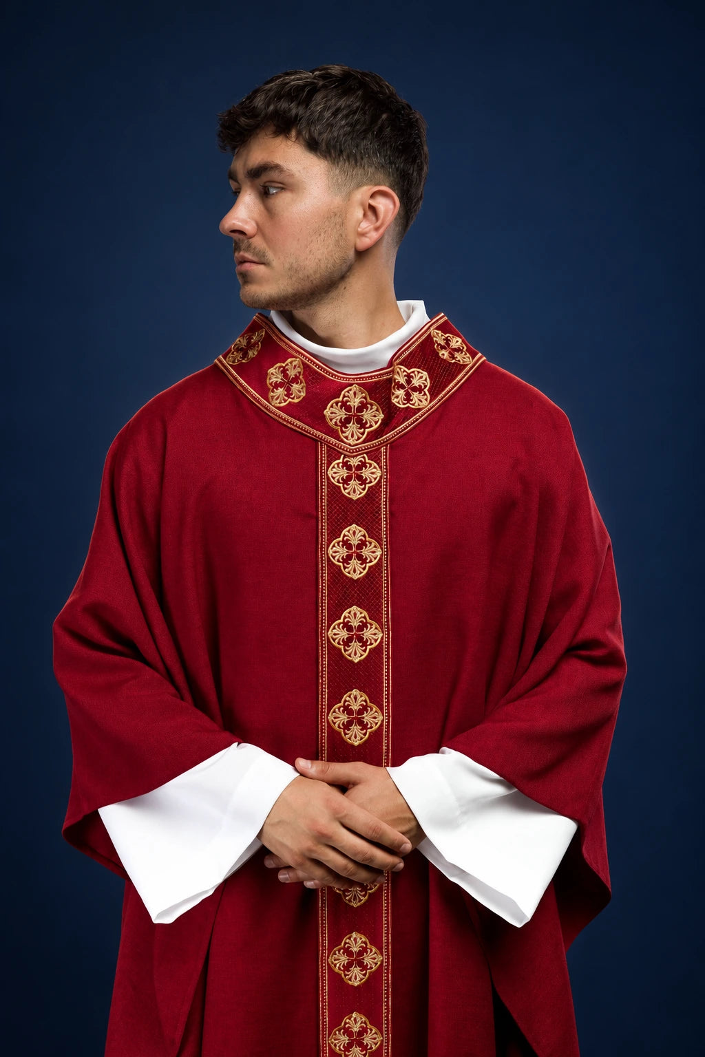 Front view of a red chasuble with embroidered gold orphrey and cross collar detail