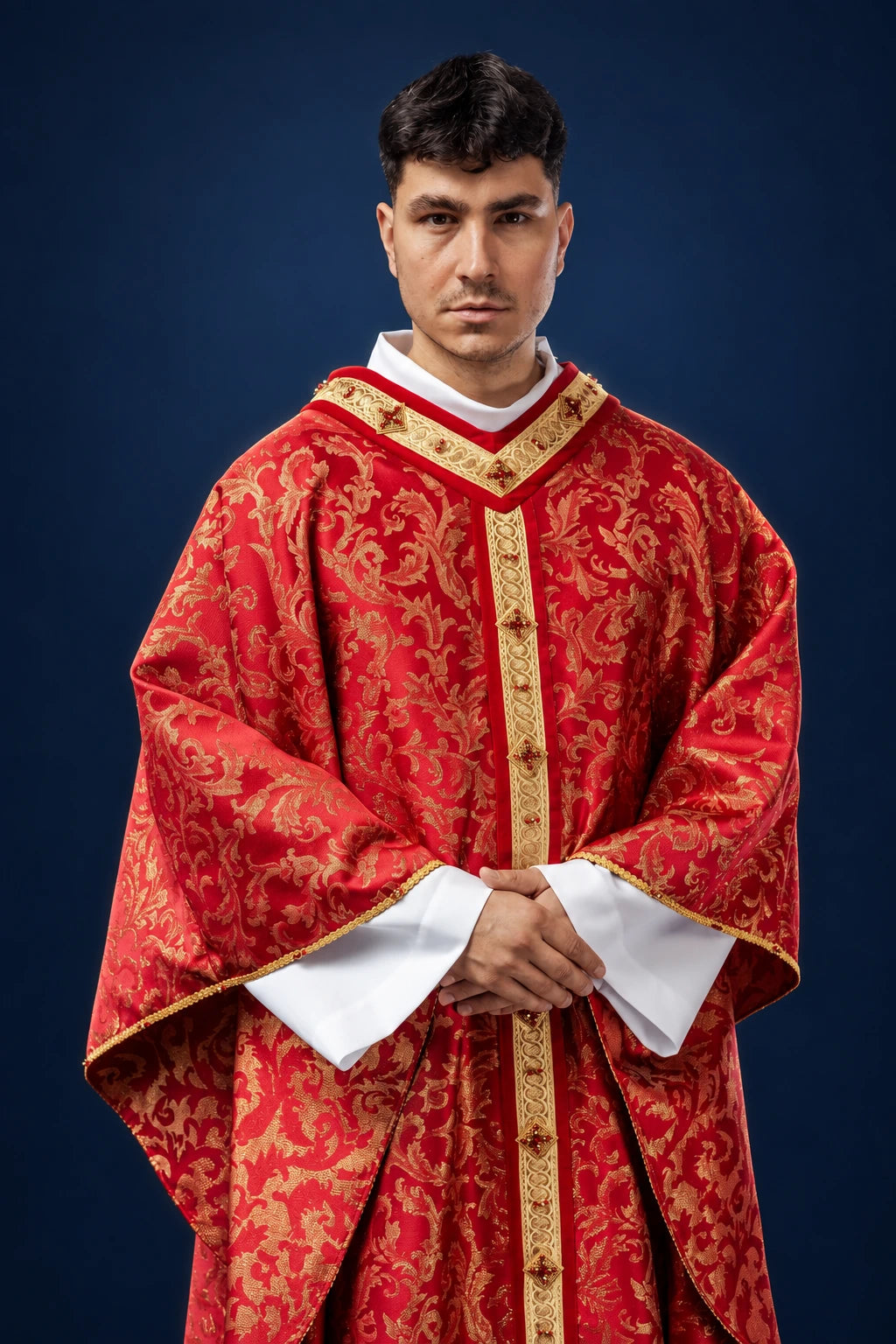 Front view of a red chasuble with gold brocade trim and vertical orphrey, worn over white vestments