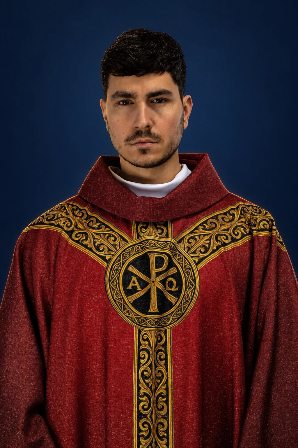 Front view of a red chasuble with gold ornamentation and a central Pax symbol on the chest