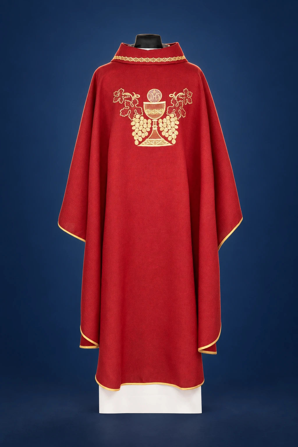 Front view of a red chasuble with gold trim and chalice-and-grapes embroidery on the chest
