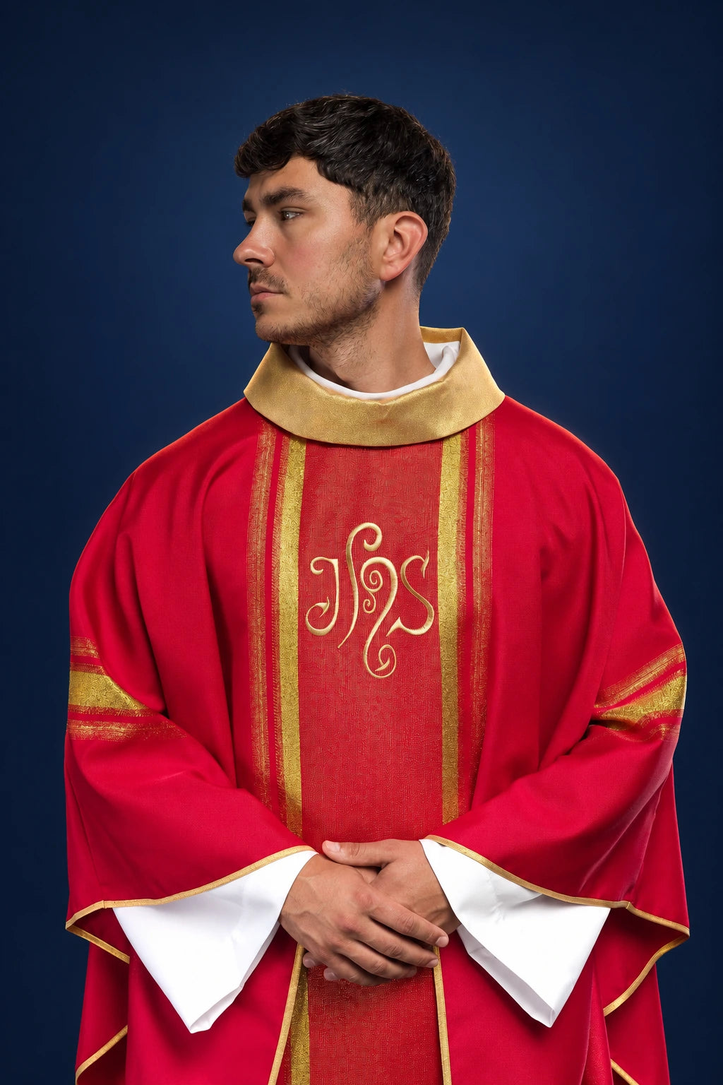 Front view of a red chasuble with gold vertical bands, gold collar, and IHS embroidery in the center