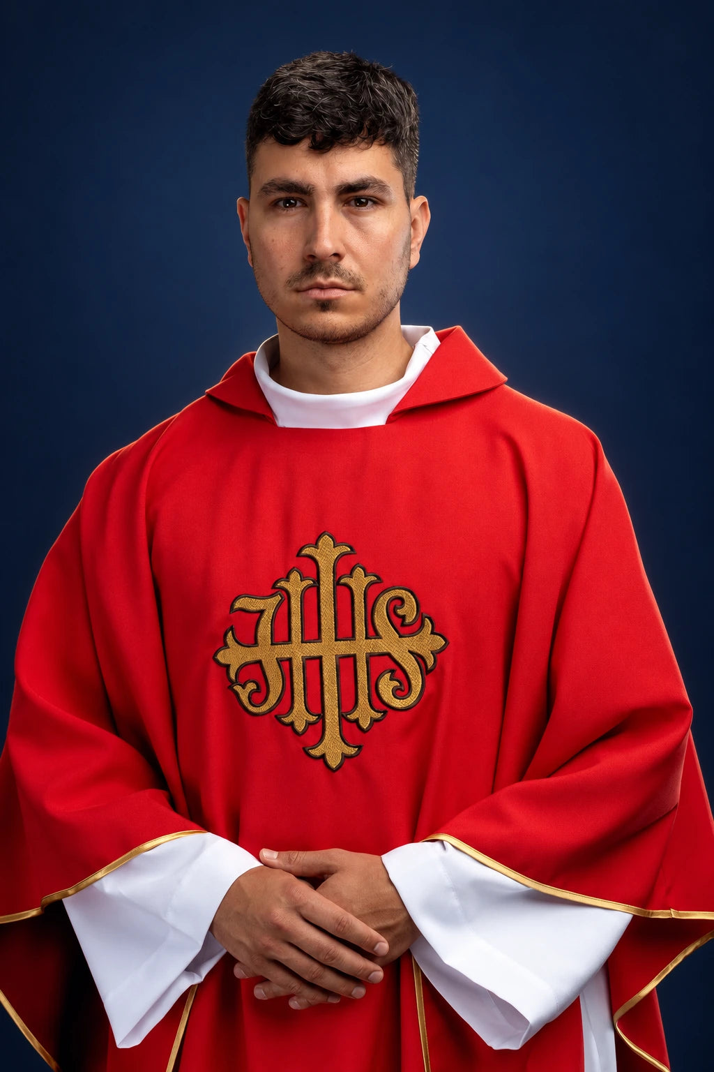 Front view of a red chasuble with wide collar and gold JHS embroidery on the chest