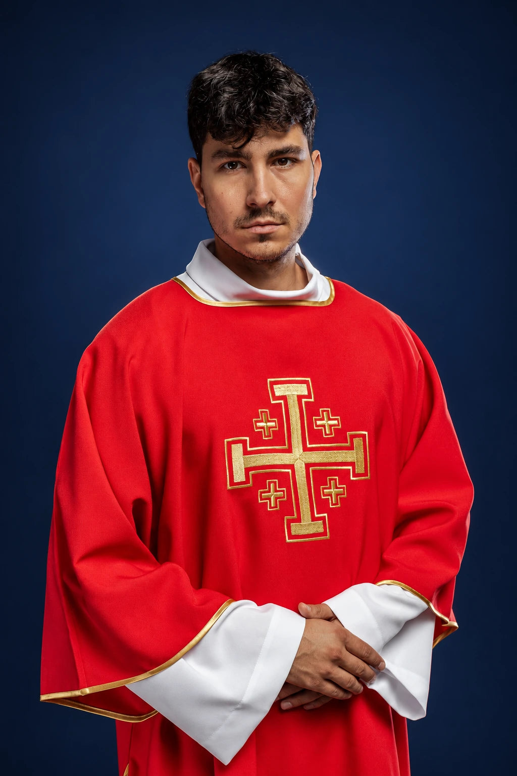 Front view of a red dalmatic with wide sleeves and embroidered gold cross on the chest